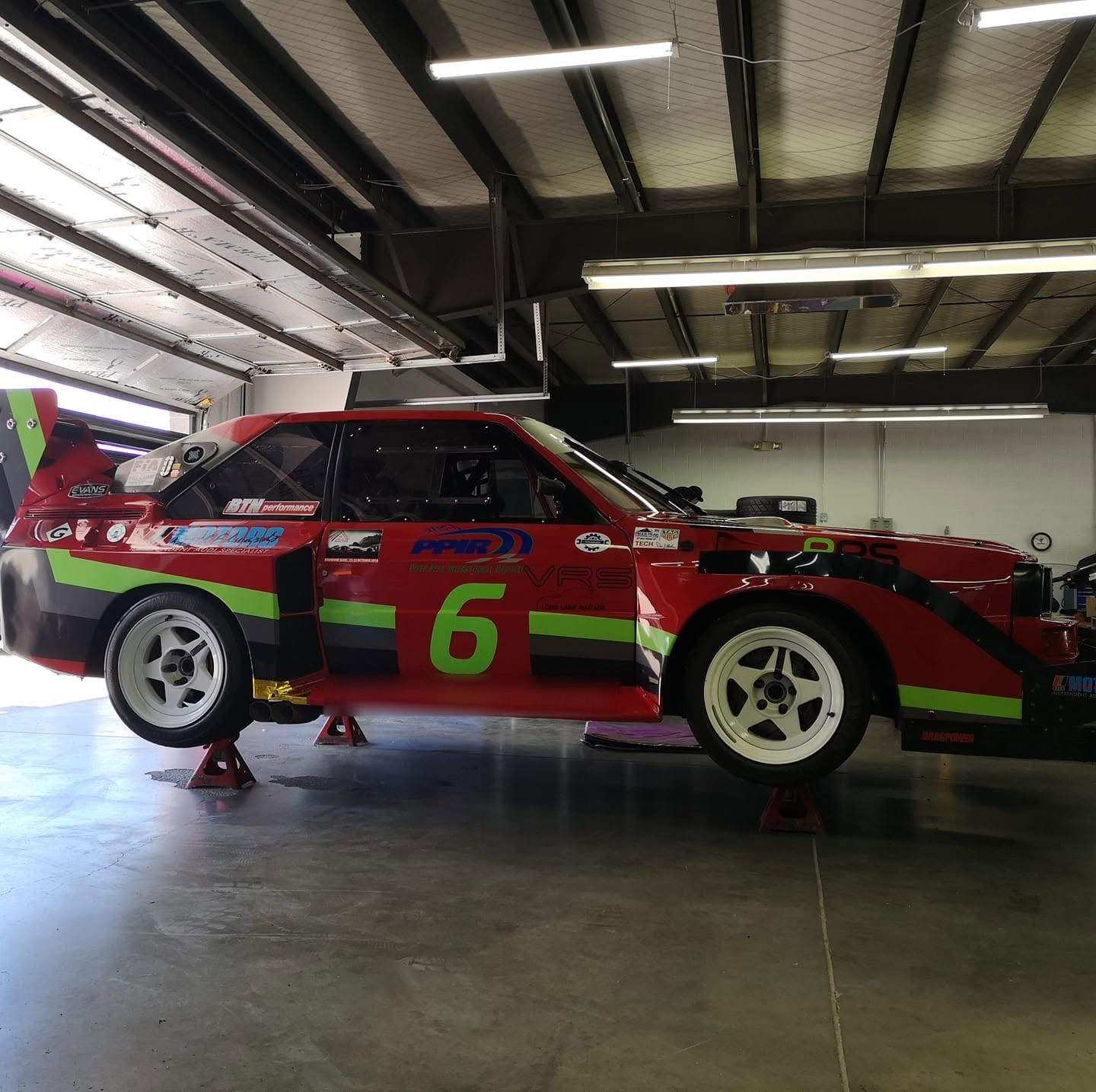 Keith's number 6 Audi Sport Quattro on axle stands in a garage