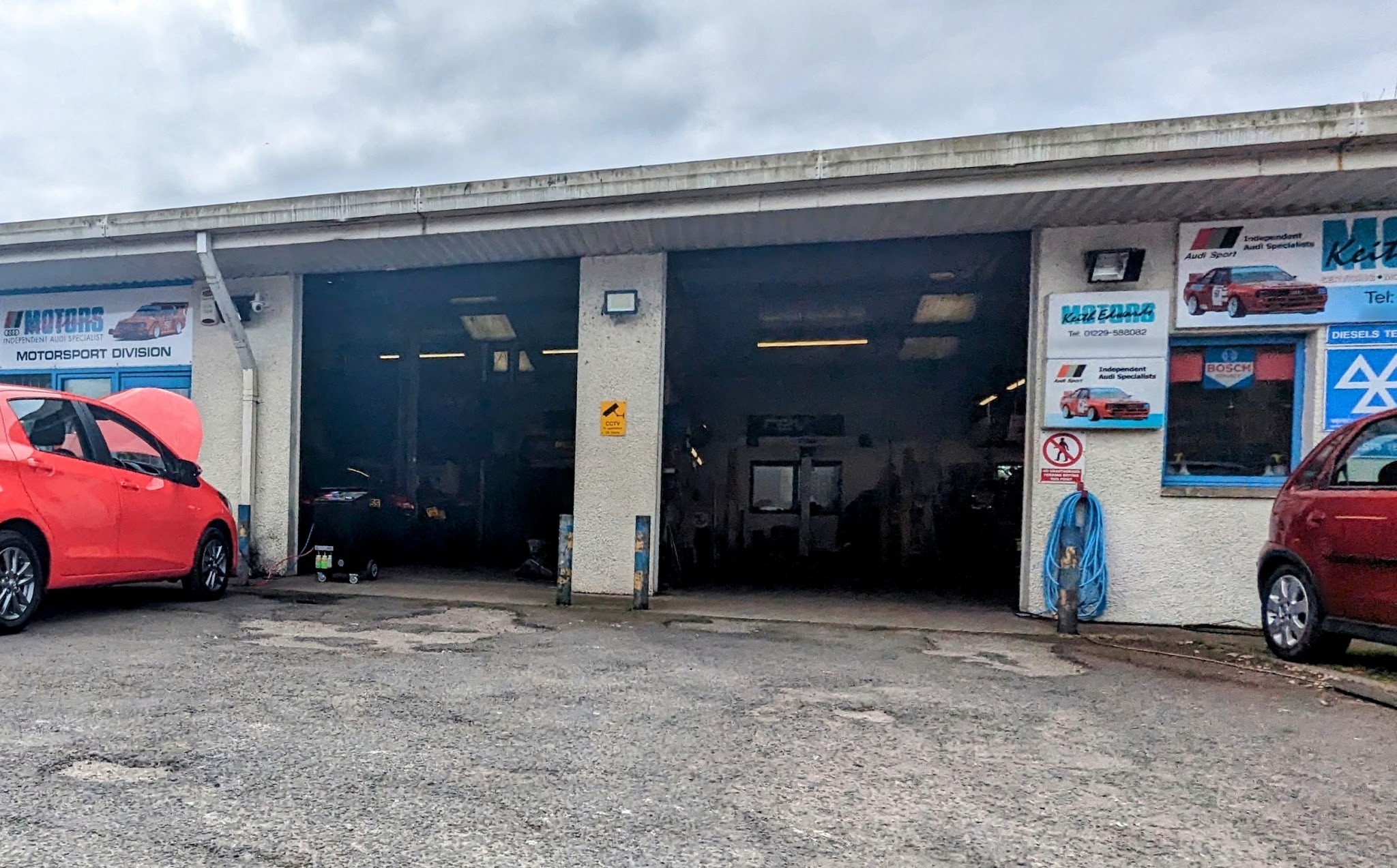 The Keith Edwards Motors workshop frontage with open bays and Independent Audi Specialists signs