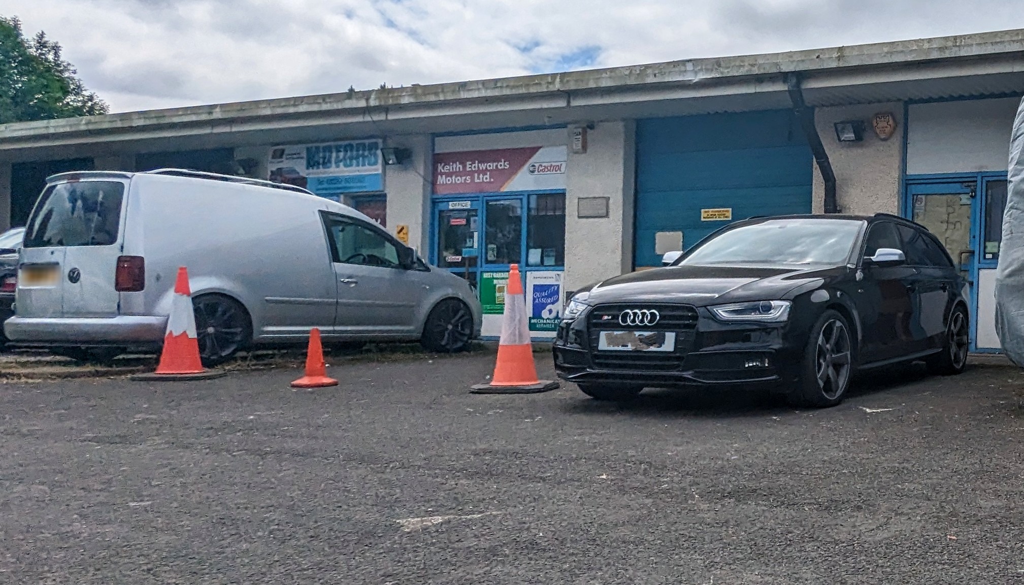 Keith Edwards Motors Ltd unit with a black Audi estate and a van outside