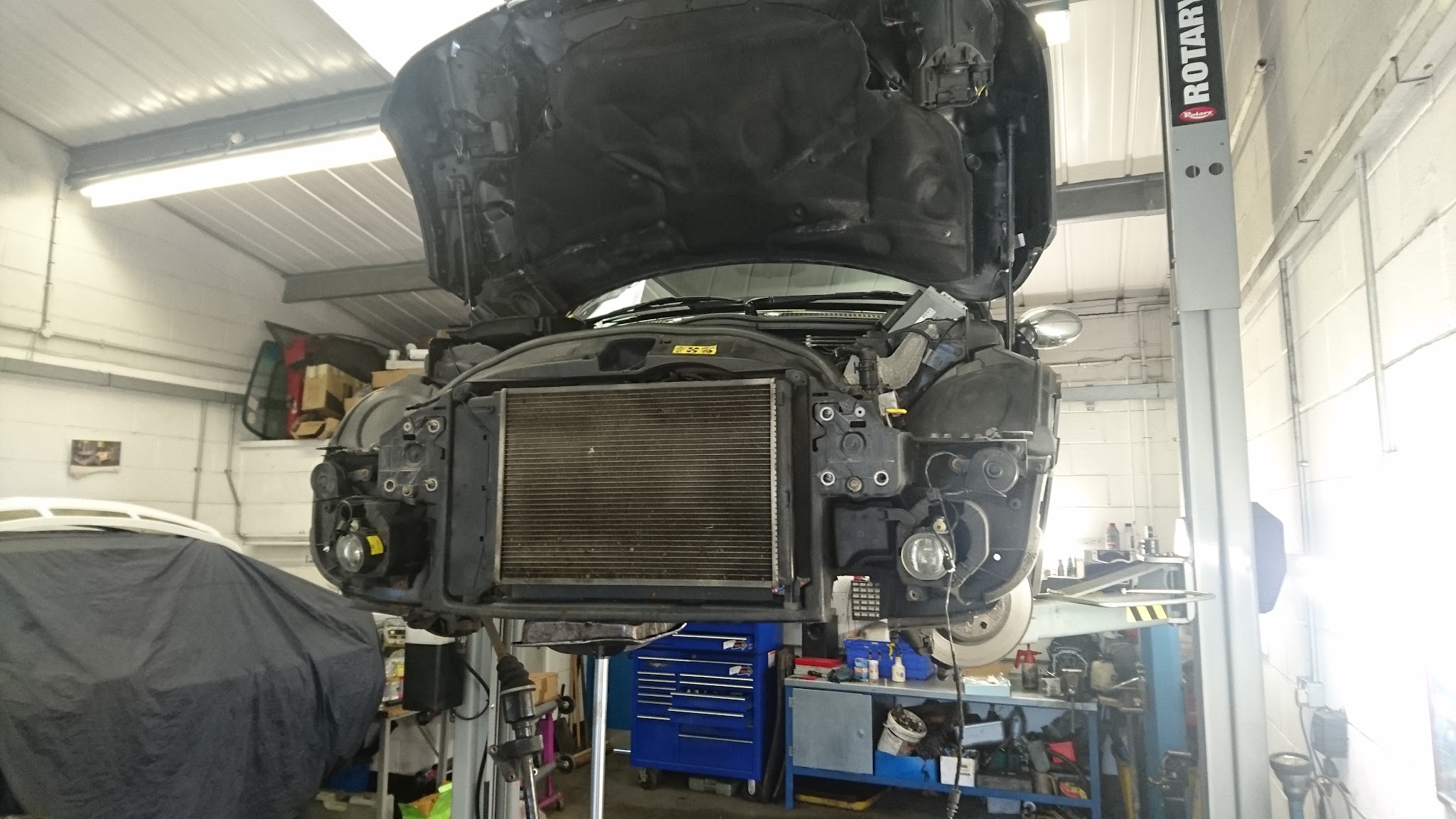 A car up on the ramp at Keith Edwards Motors with its front end stripped down for repair